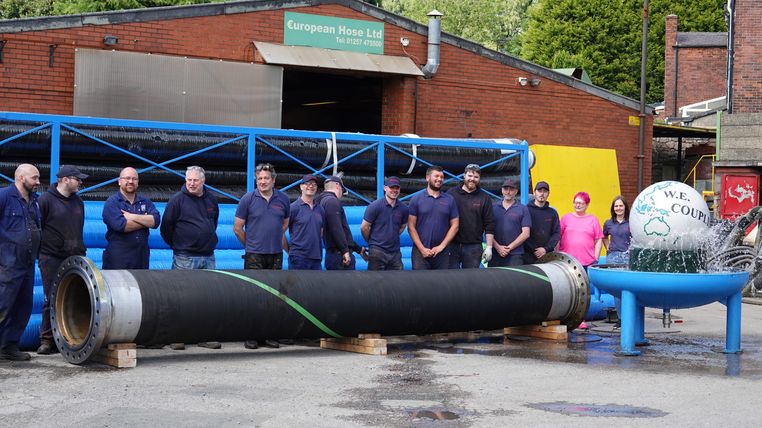 Picture of large 24 inch rubber hose with the team